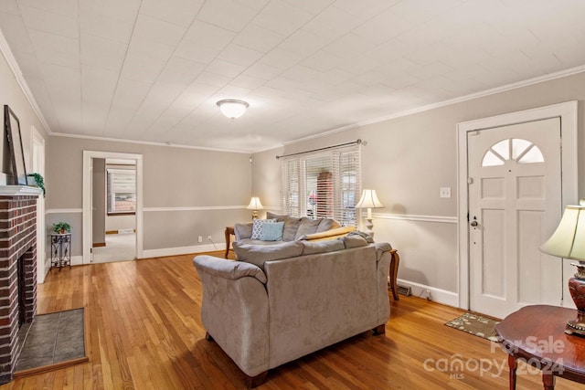 living room with a fireplace, wood-type flooring, and ornamental molding