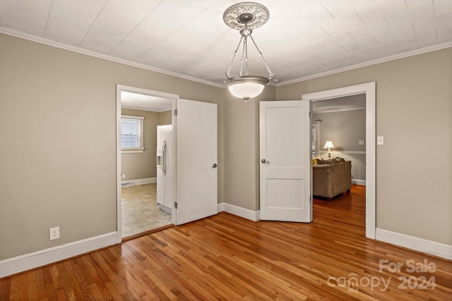 interior space with crown molding and hardwood / wood-style floors