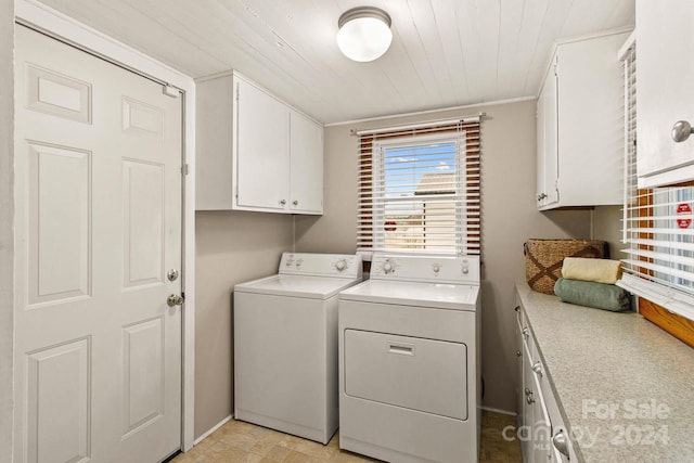 laundry area with washer and clothes dryer, cabinets, and wooden ceiling