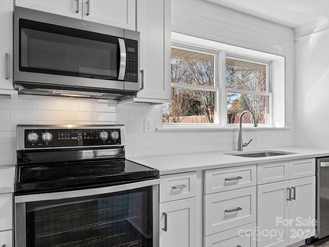 kitchen with white cabinetry and appliances with stainless steel finishes