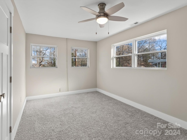 empty room featuring carpet flooring and ceiling fan