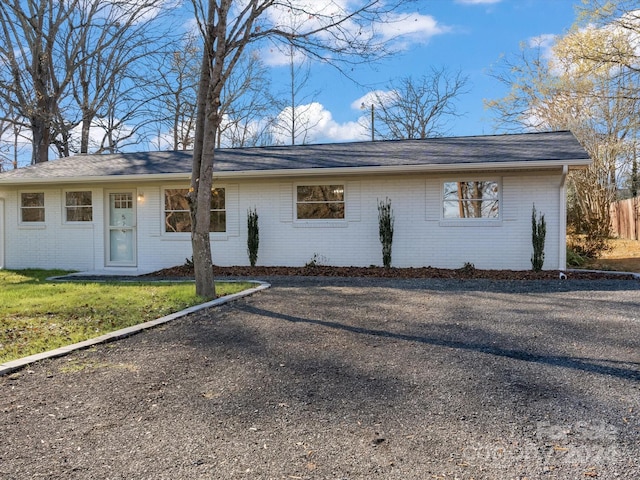 ranch-style home with a front lawn