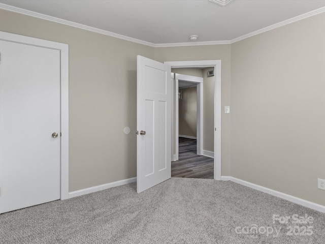 unfurnished bedroom with crown molding and carpet floors