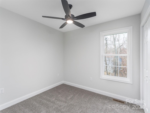 spare room featuring carpet flooring and ceiling fan