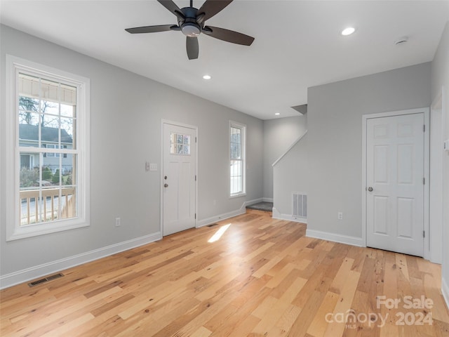 entrance foyer with light hardwood / wood-style flooring, ceiling fan, and a healthy amount of sunlight