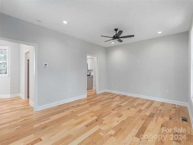 spare room featuring ceiling fan and light hardwood / wood-style flooring