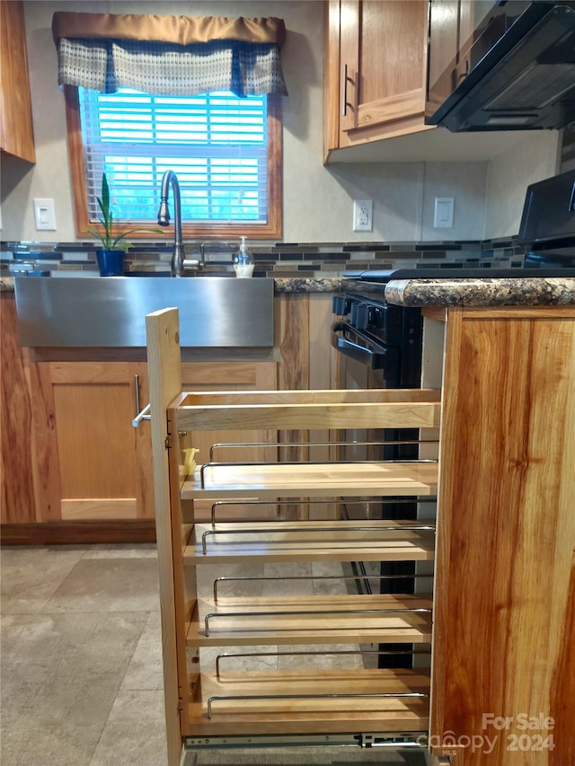 kitchen with dark stone counters and sink