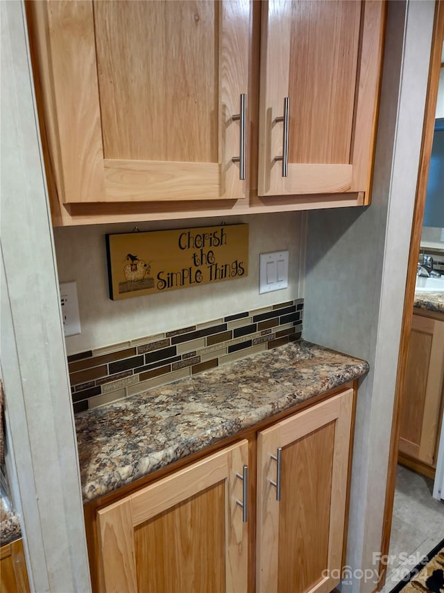 interior details featuring decorative backsplash and sink