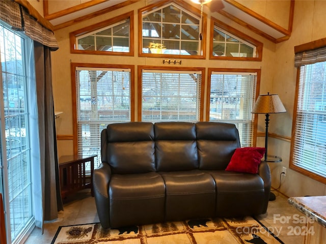 tiled living room with plenty of natural light and vaulted ceiling