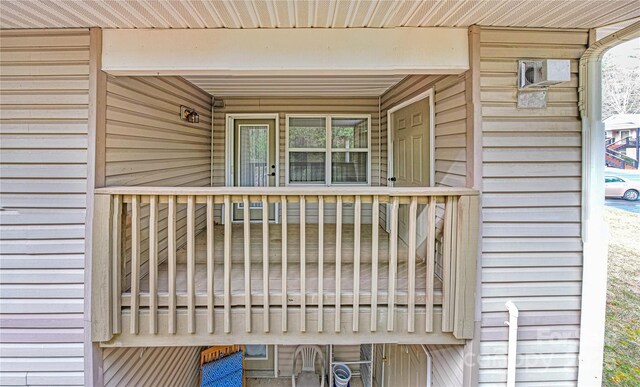 wooden terrace featuring a wall mounted AC