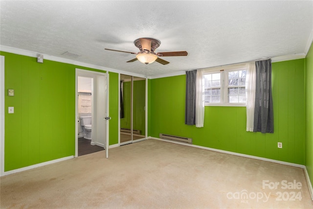 unfurnished bedroom with baseboard heating, ensuite bath, ceiling fan, and a textured ceiling