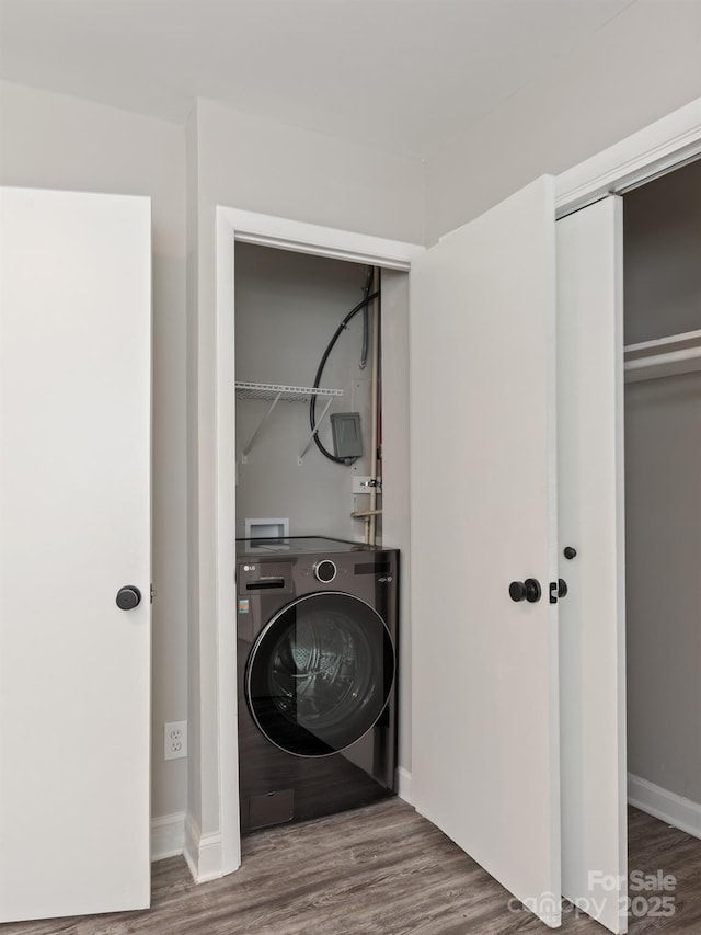 laundry area featuring washer / clothes dryer and dark wood-type flooring