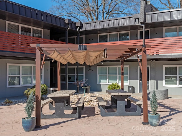 rear view of property with a pergola and a patio