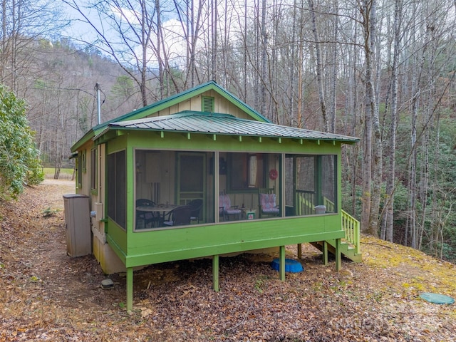 view of side of property with a sunroom