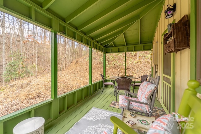 sunroom featuring lofted ceiling