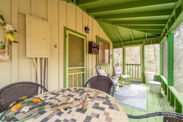 sunroom with electric panel and lofted ceiling