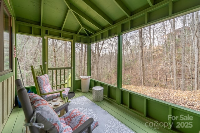 sunroom / solarium featuring vaulted ceiling