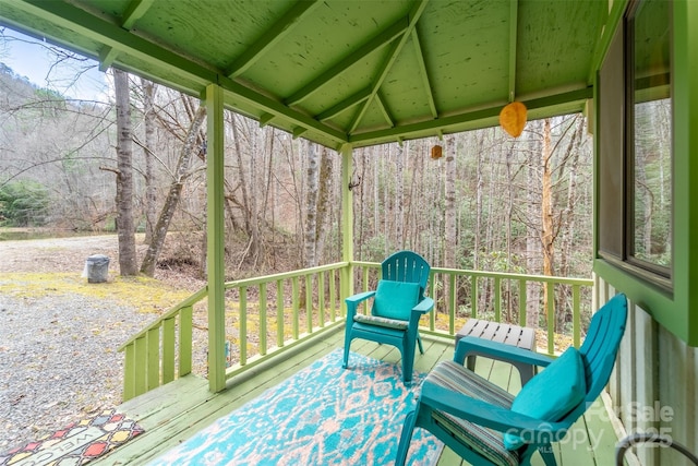 unfurnished sunroom featuring lofted ceiling