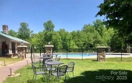 exterior space featuring a yard and a swimming pool