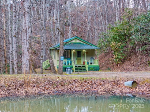 view of front of home featuring a porch and a water view