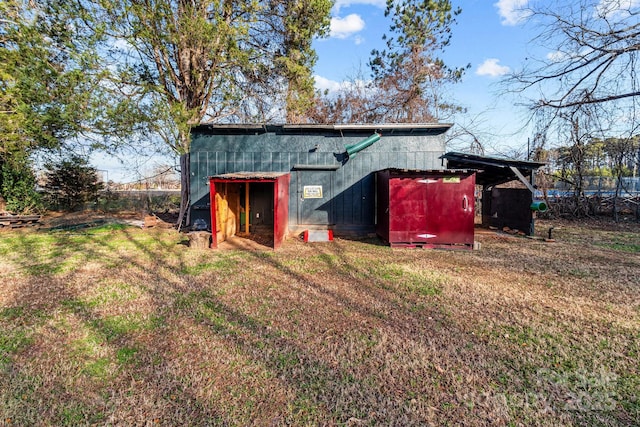 view of outbuilding featuring a yard