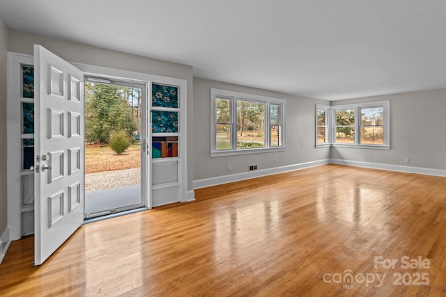 interior space with light wood-type flooring and plenty of natural light