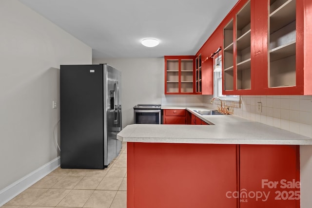 kitchen with decorative backsplash, appliances with stainless steel finishes, kitchen peninsula, and sink