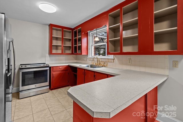 kitchen with sink, stainless steel appliances, tasteful backsplash, kitchen peninsula, and light tile patterned floors