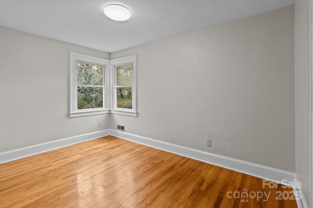 unfurnished room featuring hardwood / wood-style flooring