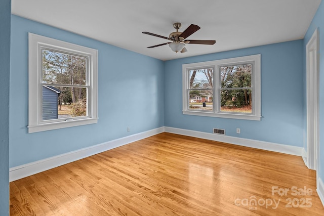 unfurnished room featuring ceiling fan, a healthy amount of sunlight, and light hardwood / wood-style flooring