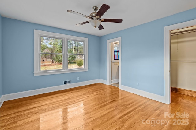 unfurnished bedroom with a closet, light hardwood / wood-style flooring, and ceiling fan