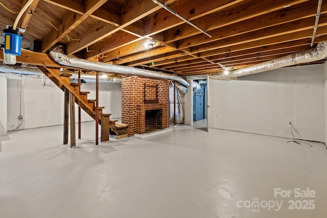 basement featuring a brick fireplace