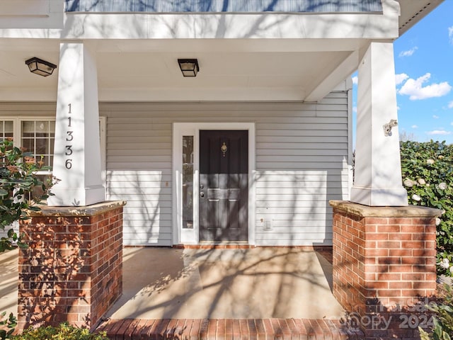 doorway to property featuring a porch