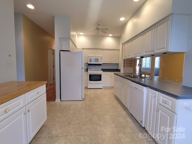 kitchen featuring white appliances, sink, kitchen peninsula, ceiling fan, and white cabinetry