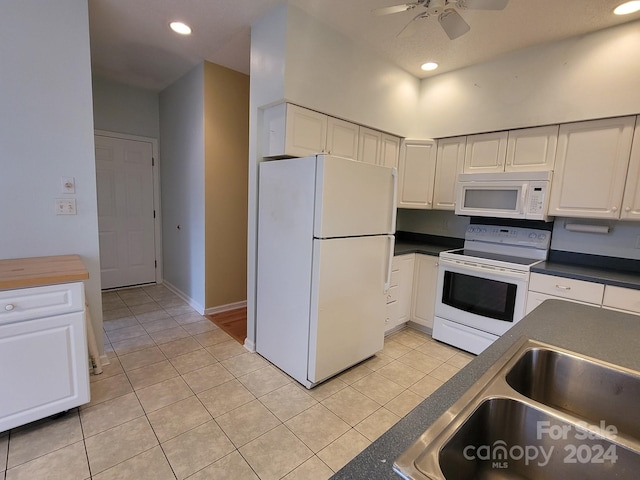 kitchen with white appliances, white cabinets, sink, ceiling fan, and light tile patterned floors