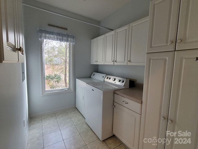 washroom with cabinets, light tile patterned floors, and separate washer and dryer