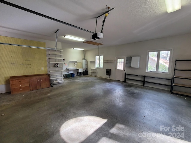 garage with a garage door opener and water heater