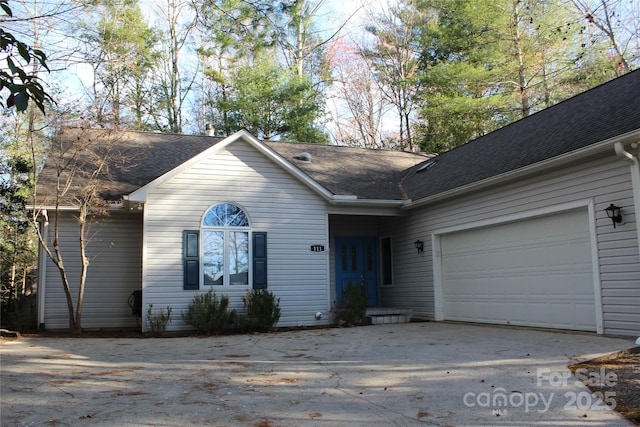 ranch-style home featuring a garage