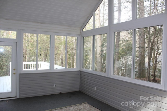 unfurnished sunroom with lofted ceiling