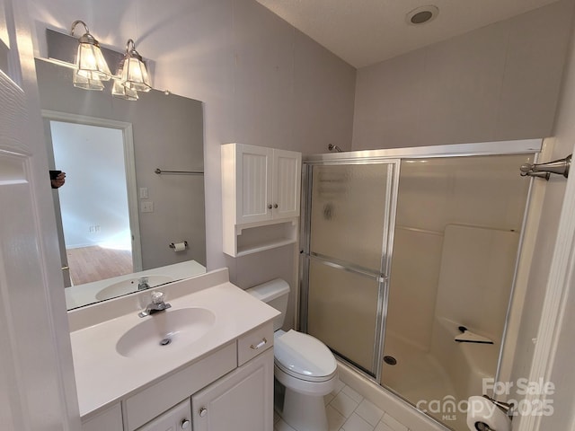 bathroom featuring toilet, a shower with shower door, an inviting chandelier, vanity, and tile patterned flooring