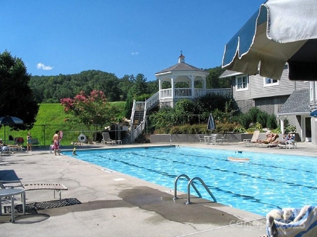 view of swimming pool with a gazebo and a patio