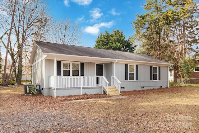 view of front of house with a porch and cooling unit