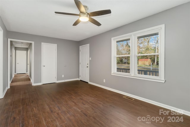 spare room featuring ceiling fan and dark hardwood / wood-style floors