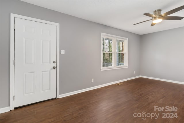 interior space featuring ceiling fan and dark wood-type flooring