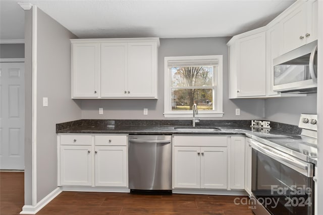 kitchen featuring white cabinets, dark hardwood / wood-style flooring, sink, and stainless steel appliances