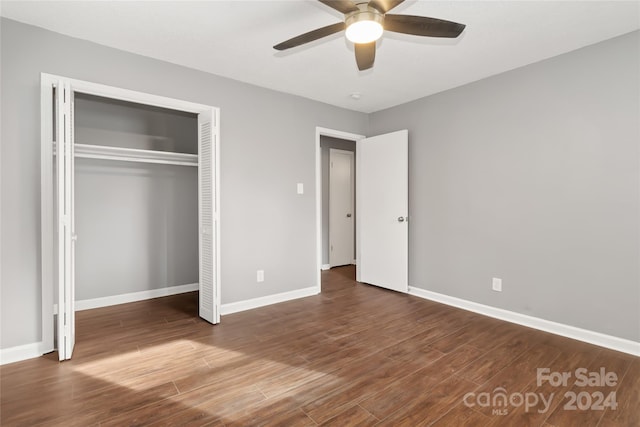 unfurnished bedroom featuring ceiling fan, dark wood-type flooring, and a closet