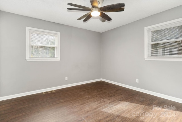 unfurnished room with ceiling fan and dark hardwood / wood-style floors