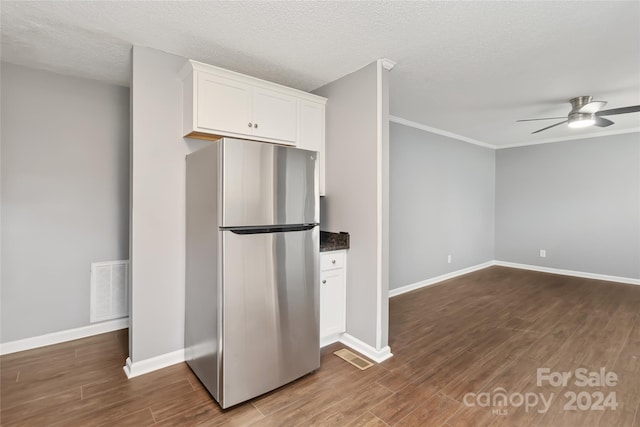 kitchen featuring dark hardwood / wood-style floors, ceiling fan, a textured ceiling, white cabinetry, and stainless steel refrigerator