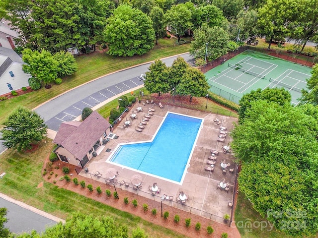 view of pool with tennis court