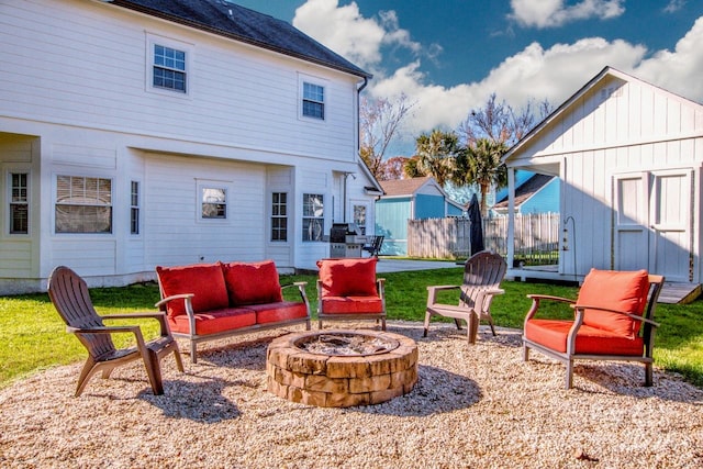 exterior space featuring an outdoor living space with a fire pit